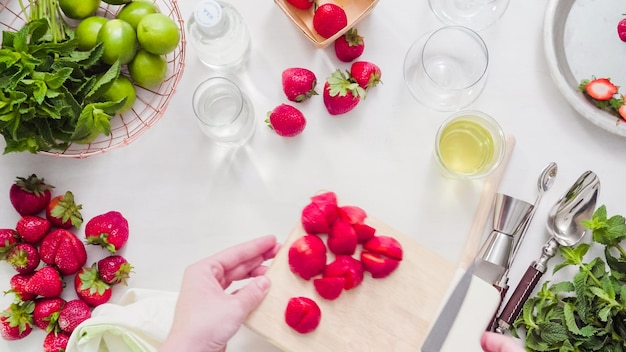 Step by step. Slicing fruit for strawberry mojito from fresh organic strawberries.