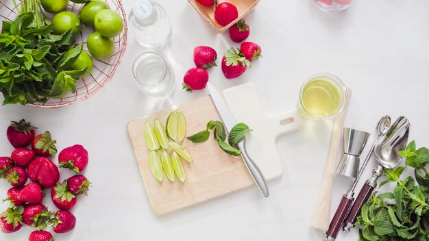 Step by step. Slicing fruit for strawberry mojito from fresh organic strawberries.