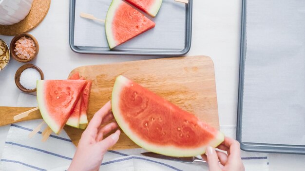 Step by step. Slicing watermelon into wadges to make watermelon ice pops.