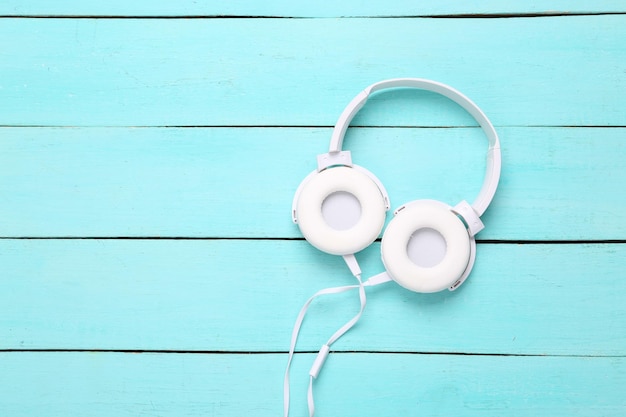 Stereo headphones on a blue wooden background Top view