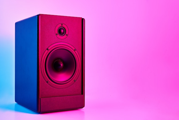 Stereo sound speaker on neon colored background