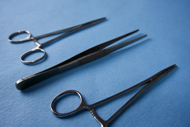 sterile surgical instruments closeup on a blue background