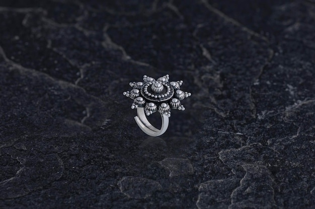 Sterling Silver Ring on Black Stone Background