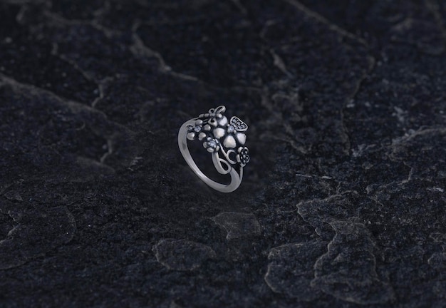 Sterling Silver Ring on Black Stone Background