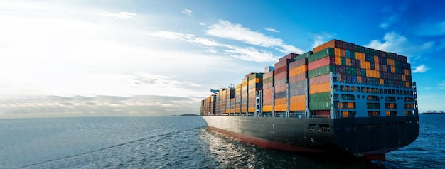 Stern of large cargo ship import export container box on the ocean sea on blue sky back ground