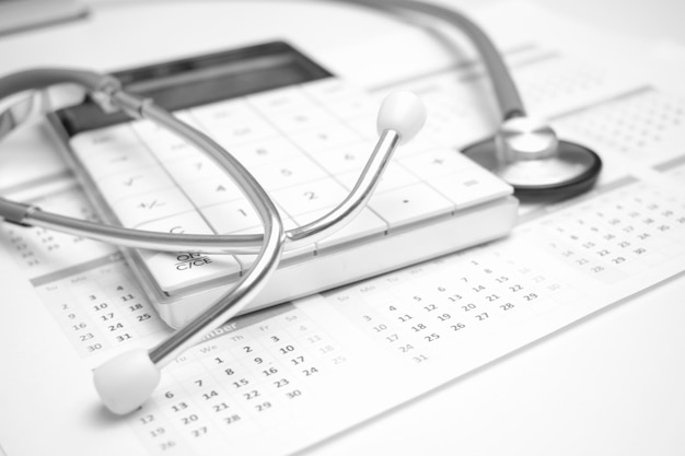 Stethoscope and callculator on the calendar Medical concept