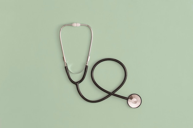 Stethoscope on green background. Top view. Flat lay. Medicine concept.