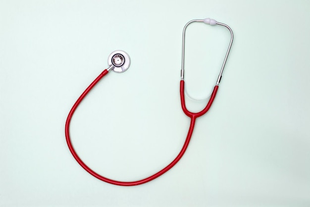 Stethoscope on green background top view. Medical tool