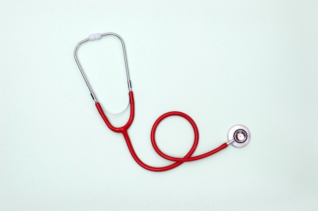 Stethoscope on green background top view. Medical tool