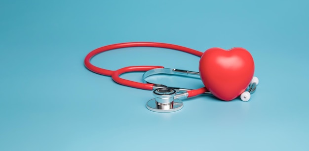 Stethoscope and heart examination red on blue background healthcare concept