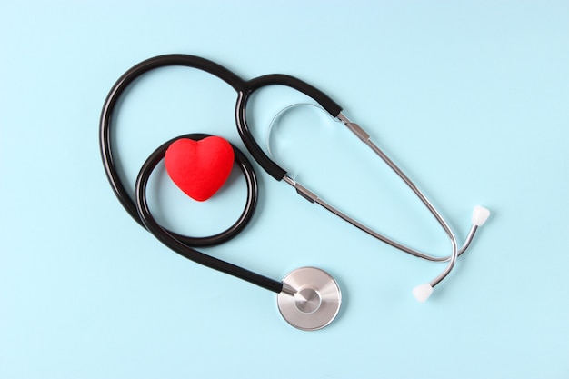 Stethoscope and heart on wooden color background health medicine