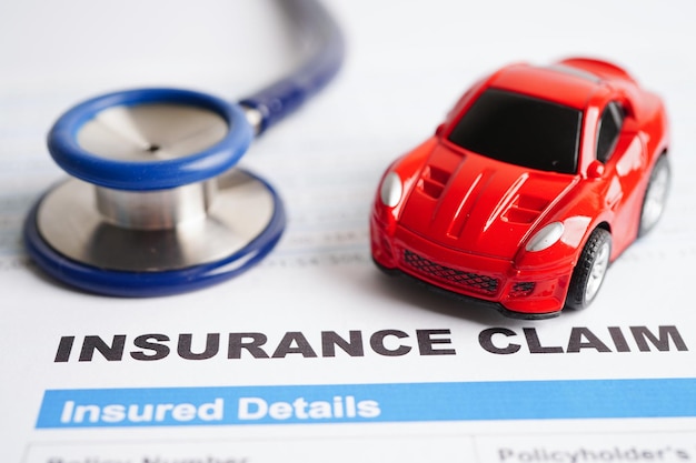 Stethoscope on Insurance claim accident car form Car loan insurance and leasing time concepts