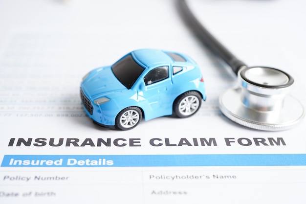 Stethoscope on Insurance claim accident car form Car loan insurance and leasing time concepts