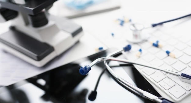 Photo stethoscope lies on computer white keyboard closeup