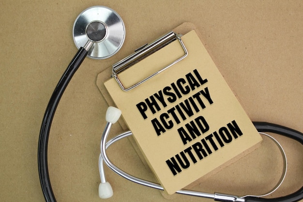 stethoscope and paper board writing with the words Physical Activity and Nutrition