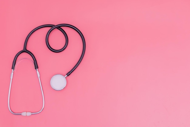 Stethoscope on pink background and copy space