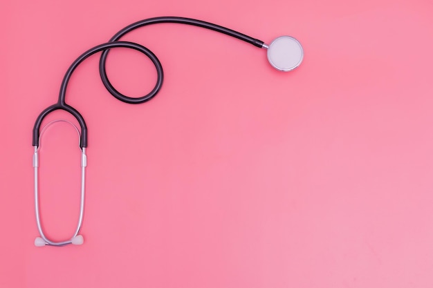 Stethoscope on pink background and copy space