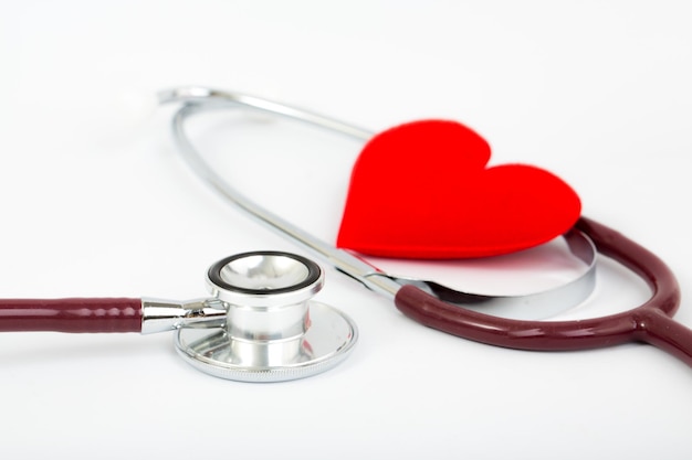 stethoscope and red heart on white background.