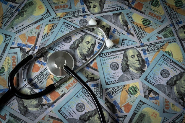 A stethoscope on stack of dollar banknote.