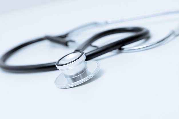 Stethoscope on table. Isolated on white background. Studio lighting. Concept for healthy and medical