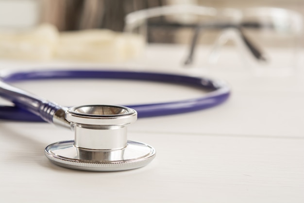 Stethoscope, vital signs headphones on the counter, doctor work and tools