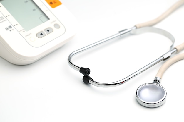 Stethoscope with Electronic Blood Pressure Monitor or Sphygmomanometer on the white background. Healthcare concept.