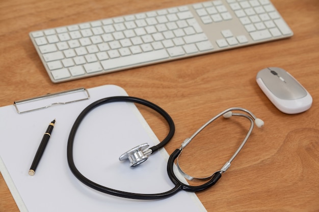 Stethoscope with keyboard and mouse on table