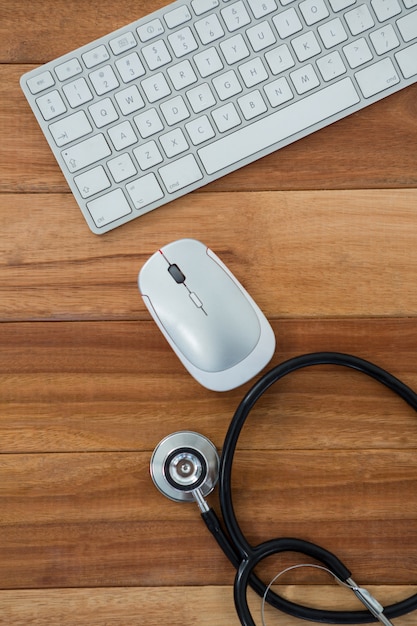 Stethoscope with keyboard and mouse on table