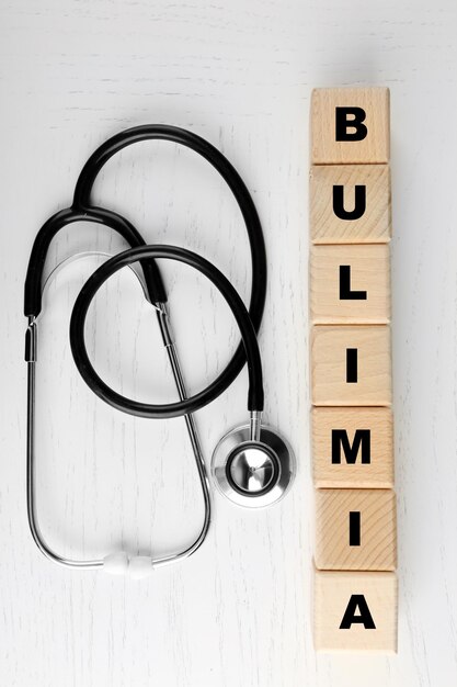 Stethoscope and wooden cubes top view