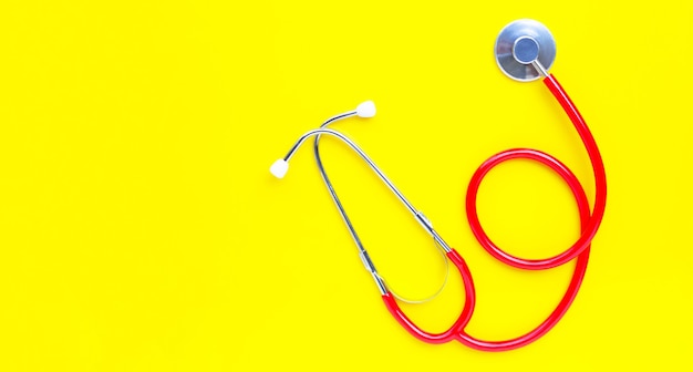 Stethoscope on yellow background. copy space