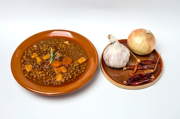 Stew of lentils with chorizo and pork.Isolated