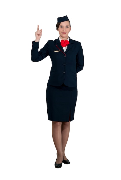 Stewardess in full growth on a white background stands and shows the index finger up