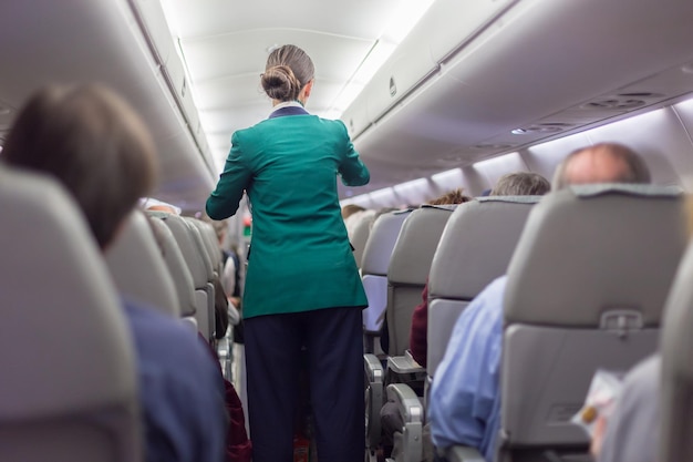 Stewardessand passengers on commercial airplane