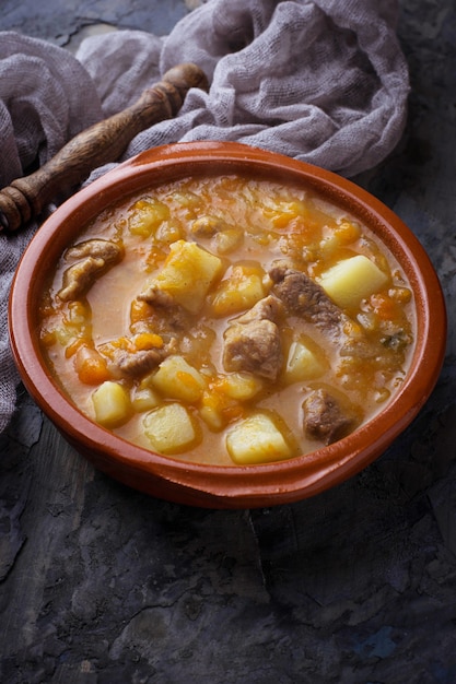 Photo stewed beef with potatoes, carrot and pumpkin. selective focus