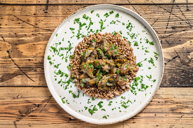 Photo stewed chicken stomachs with vegetables and buckwheat.