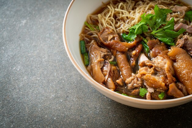 Stewed pork leg noodles in brown soup - Asian food style