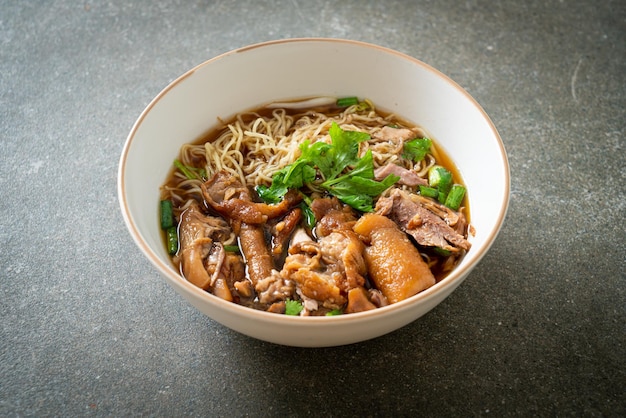 Stewed pork leg noodles in brown soup - Asian food style