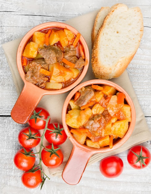 Stewed potatoes with meat carrots and tomatoes