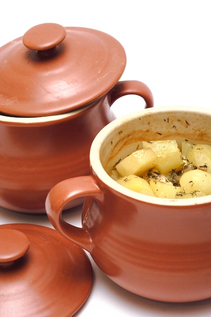 Stewed potatoes with a meat at the pot. Ukrainian traditional dish