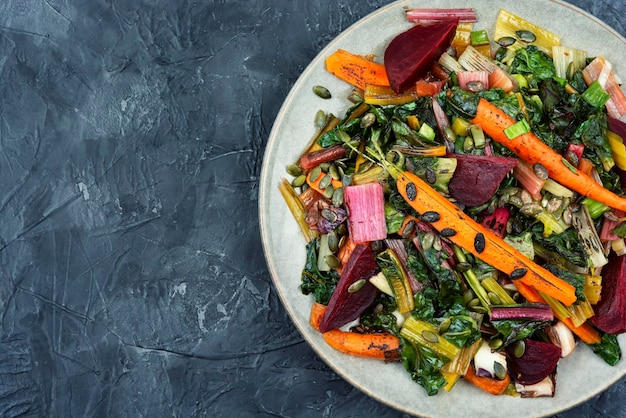 Stewed vegetables and chard leaves copy space