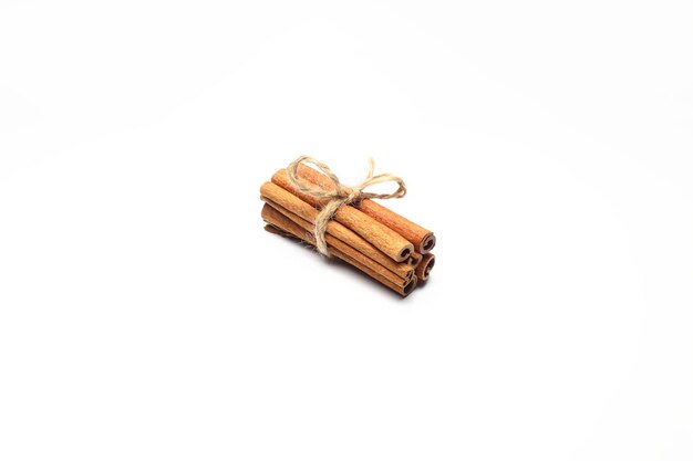 sticks of dry cinnamon tied with a twine rope on a white background isolate for designers