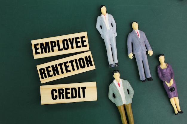 sticks and miniature people with the word Employee Retention Credit the concept of employee salary