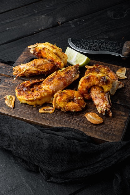 Sticky Mango Prawns or shrimps on wooden board on black wooden table background