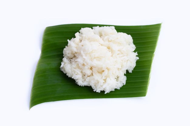 Sticky rice on banana leaf in bamboo basket on white background