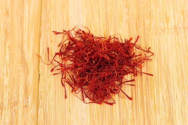 Stigmas of saffron on wooden background closeup