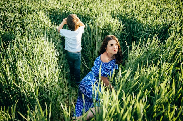 Stilish mother and handsome son having fun on the nature.