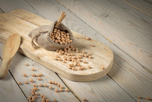 Still life chickpeas in a bag on a wooden table