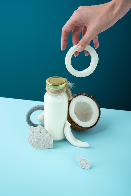 Photo still life creative minimalistic concept alternative milk coconut products cracked open coconut with