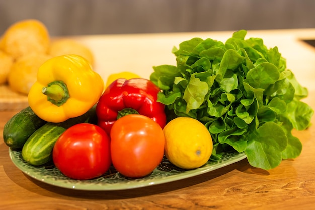 Still life of fresh organic vegetables on plate on kitchen vegetarian and vegan concept