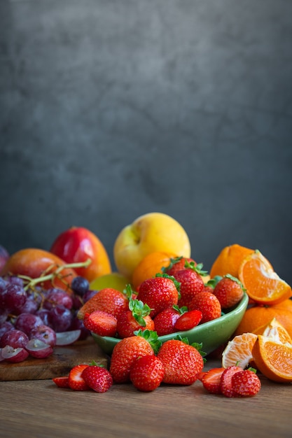 Still life of fresh seasonal fruits of reddish tones